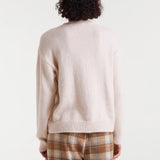 Women's cream graphic sweater with red Après Ski slogan, a cozy winter knit for ski trips, mountain holidays and après ski style.