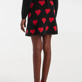 Black heart print mini skirt for women featuring bold red hearts and a flattering A-line shape for playful statement outfits.
