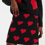Women’s black and red heart skirt with short A-line silhouette for romantic party looks and trendy casual fashion.