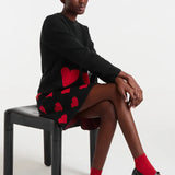 Women’s black and red heart pattern mini skirt for playful party, romantic, and going-out fashion.