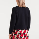 Back view of casual chic women’s cardigan styled with playful Valentine-inspired aesthetic