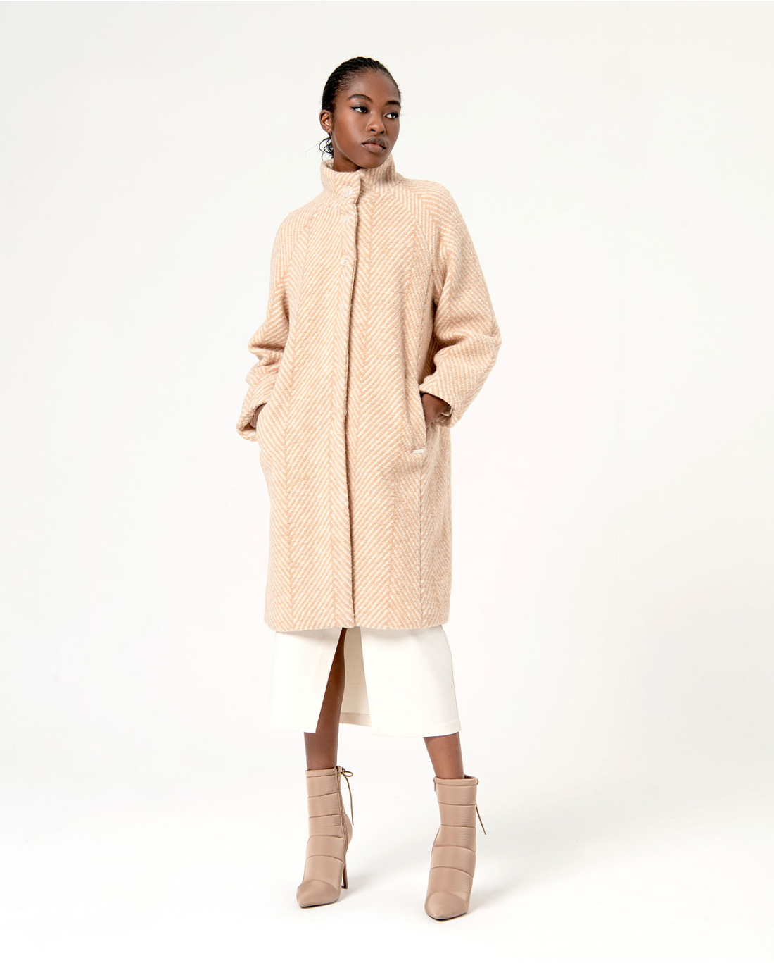 Chic camel wool-blend overcoat featuring subtle herringbone texture and sophisticated modern tailoring.