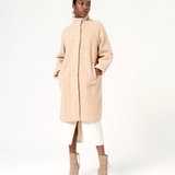 Chic camel wool-blend overcoat featuring subtle herringbone texture and sophisticated modern tailoring.