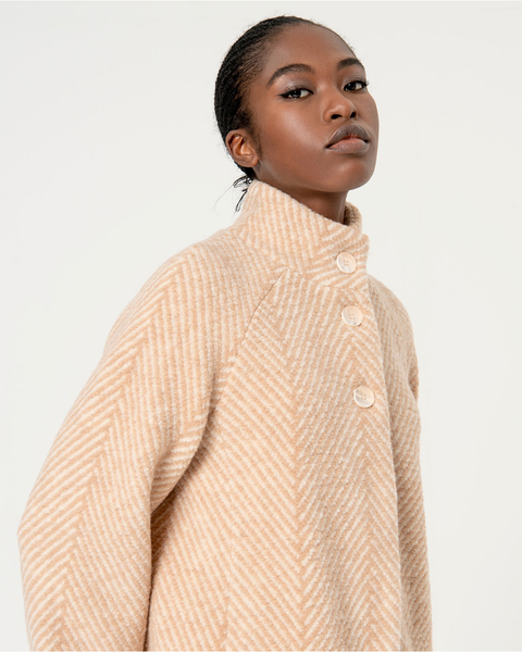 Minimalist herringbone beige midi coat with high neckline and polished timeless outerwear boutique fashion appeal.