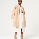 Trendy women’s wool-look coat with soft herringbone texture and elegant neutral winter outfit inspiration.