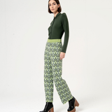 Trendy green and black print trousers featuring artistic geometric design and contemporary urban fashion vibe.