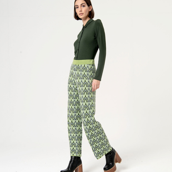 Trendy green and black print trousers featuring artistic geometric design and contemporary urban fashion vibe.