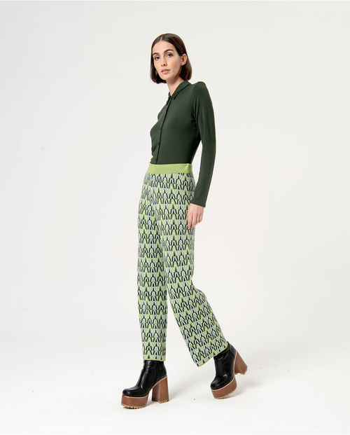 Trendy green and black print trousers featuring artistic geometric design and contemporary urban fashion vibe.