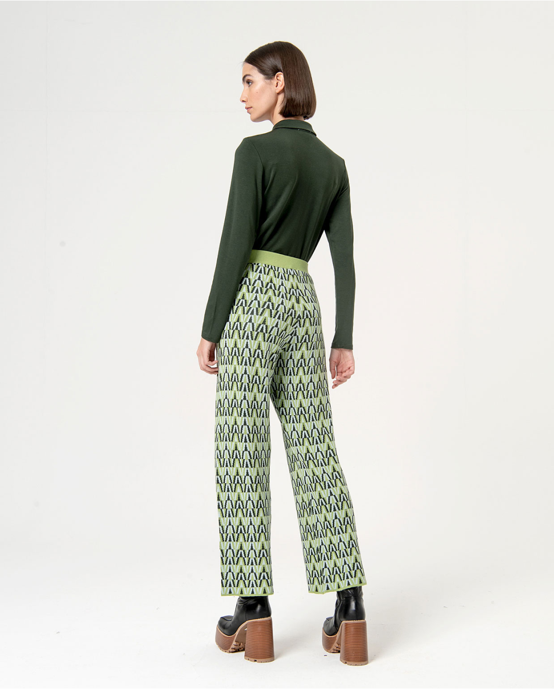Women’s cropped geometric pants paired with platform ankle boots for trendy street-style inspiration.