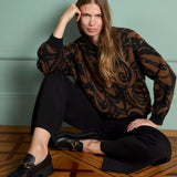 Women’s full-length black wide-leg trousers with relaxed fit and pockets for versatile office, travel, and smart casual outfits.