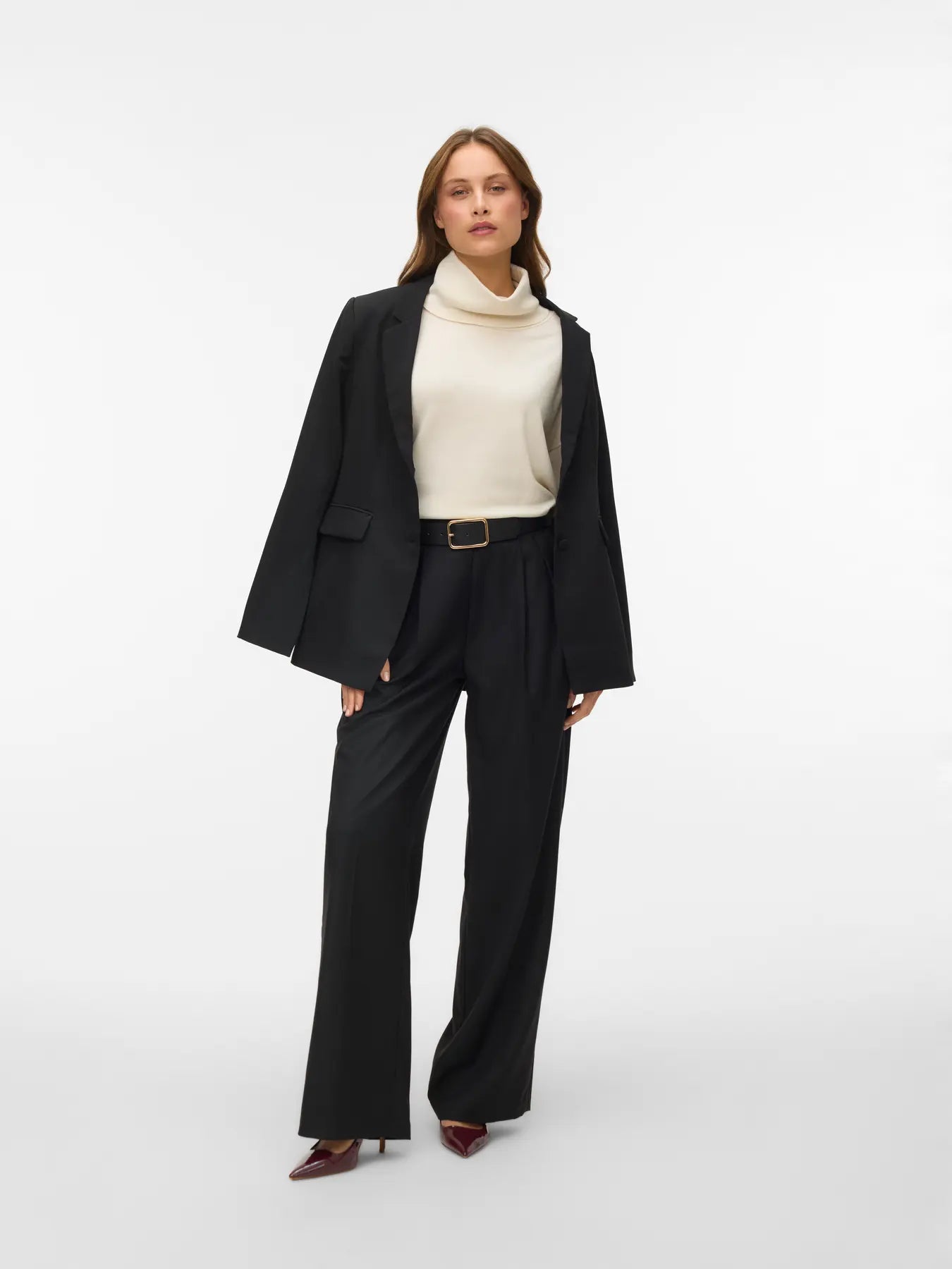 Women's minimalist birch colored roll-neck sweater featuring a relaxed silhouette for versatile work, travel and everyday styling.