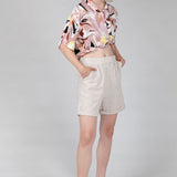 Women's beige bermuda shorts with rolled cuffs and breathable linen fabric.