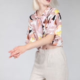 Relaxed fit oatmeal linen bermuda with rolled cuff-shorts perfect for minimalist capsule wardrobes.
