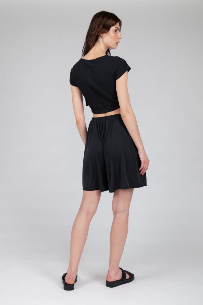 Women's minimalist black wide-legged flowy shorts designed for versatile capsule wardrobe styling.