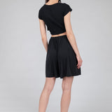 Women's minimalist black wide-legged flowy shorts designed for versatile capsule wardrobe styling.