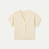 Women's contemporary cream V-neck blouse with wrap-inspired front, statement buttons and effortless minimalist fashion for casual chic outfits.