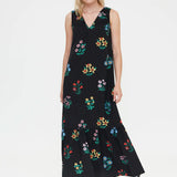 Women's black floral print maxi dress with sleeveless design, colorful botanical pattern and tiered hem for summer vacations and resort style.