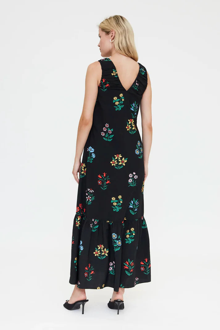 Lightweight black floral summer maxi dress with sleeveless silhouette, feminine tiered hem and elegant casual style for warm-weather occasions.