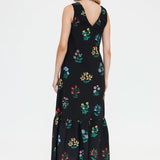 Lightweight black floral summer maxi dress with sleeveless silhouette, feminine tiered hem and elegant casual style for warm-weather occasions.