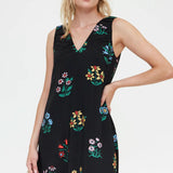 Women's lightweight black summer dress with multicolor floral print, sleeveless design and feminine tiered hem for effortless everyday elegance.