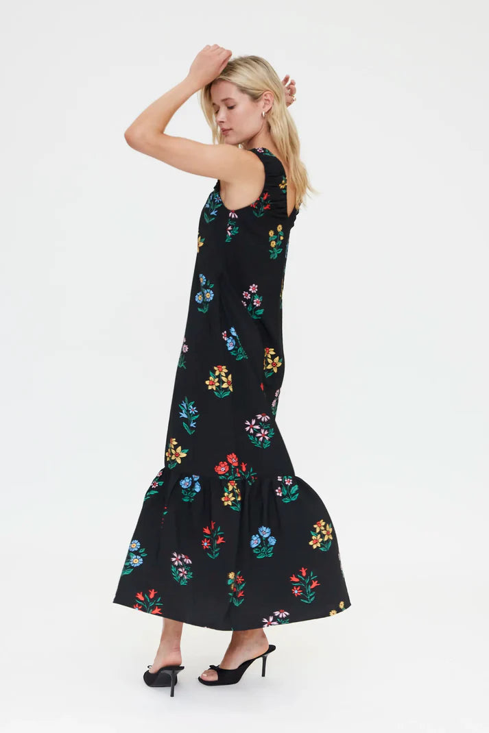 Elegant black sleeveless maxi dress featuring vibrant multicolor floral print, relaxed silhouette and ruffle hem for effortless summer fashion.
