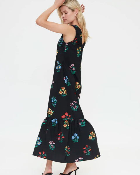 Elegant black sleeveless maxi dress featuring vibrant multicolor floral print, relaxed silhouette and ruffle hem for effortless summer fashion.