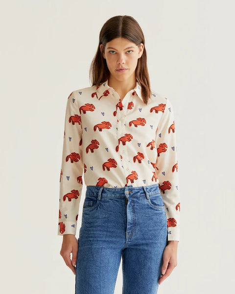 Women's ivory button-up blouse with coral leopard print, blue heart accents and long sleeves for playful boutique fashion and everyday style.