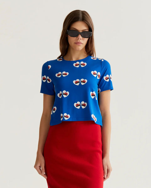 Women's royal blue ladybug heart print top with short sleeves, crew neckline and relaxed fit for playful summer style and boutique fashion.