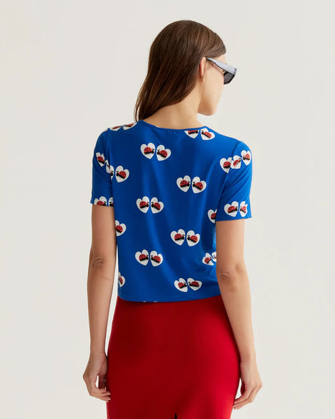 Bright cobalt blue short sleeve knit top featuring whimsical ladybug heart print and lightweight fabric for casual everyday wear.
