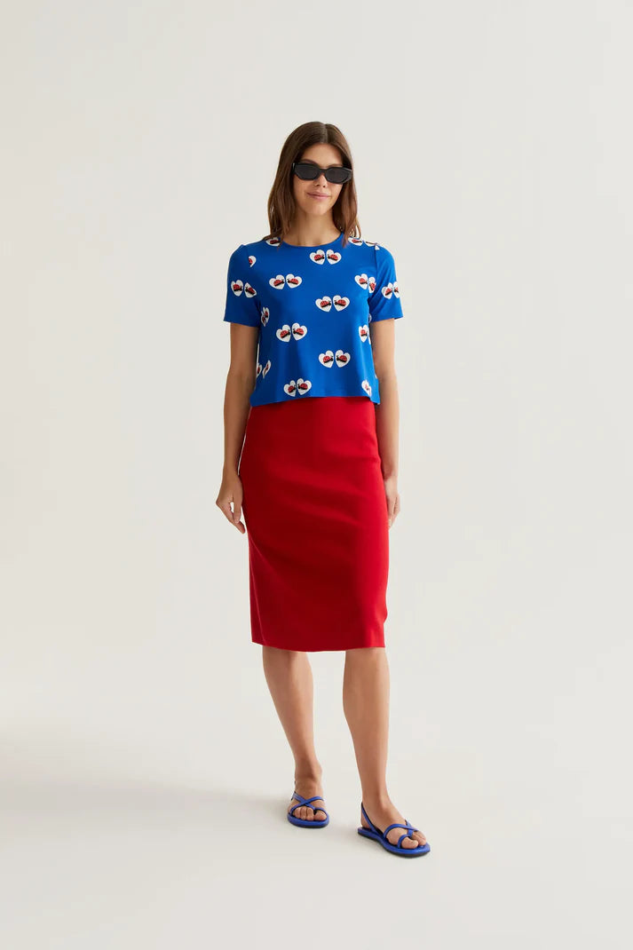 Premium boutique cobalt blue graphic top with whimsical heart and ladybug print, soft stretch fabric and modern casual styling for everyday wear.