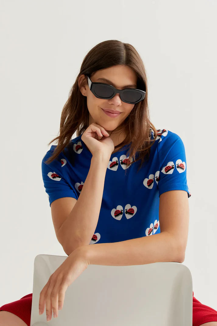 Designer-inspired royal blue casual top with novelty ladybug heart print, crew neck and lightweight construction for playful boutique wardrobes.