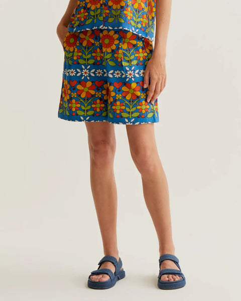 Women's blue retro floral print shorts with colorful botanical pattern, side pockets and relaxed fit for summer vacations and resort style.