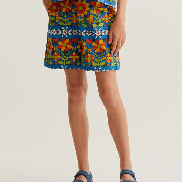 Women's blue retro floral print shorts with colorful botanical pattern, side pockets and relaxed fit for summer vacations and resort style.