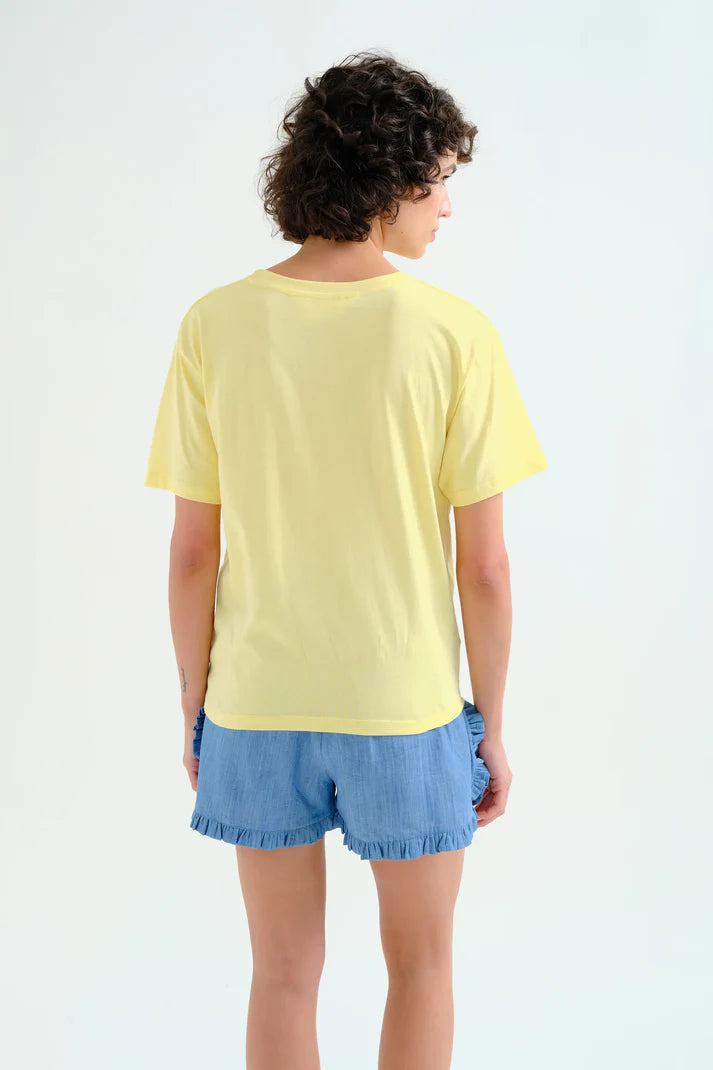 Contemporary graphic cotton tee showcasing modern abstract chair artwork with rolled sleeves and relaxed casual styling.