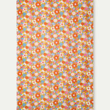 Floral patterned fabric of the sarong with colorful flowers on a white background.