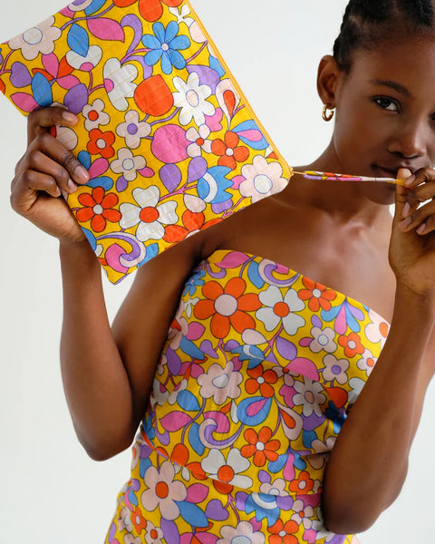 Colorful vintage-inspired floral zip pouch with quilted fabric, spacious interior, and bold yellow background for stylish travel essentials.