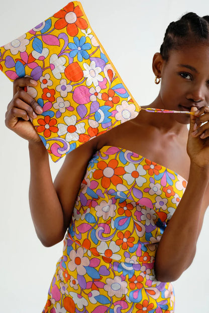 Beautiful model holding cotton bag with colorful floral print, fun makeup multi-functional bag.