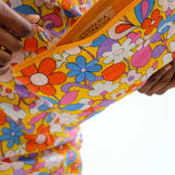 Women's floral accessory pouch with padded quilted fabric, secure zipper, and colorful retro floral pattern for travel and daily use.