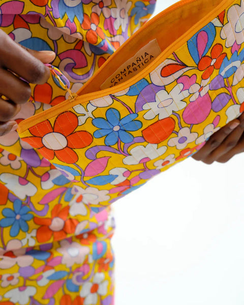 Women's floral accessory pouch with padded quilted fabric, secure zipper, and colorful retro floral pattern for travel and daily use.