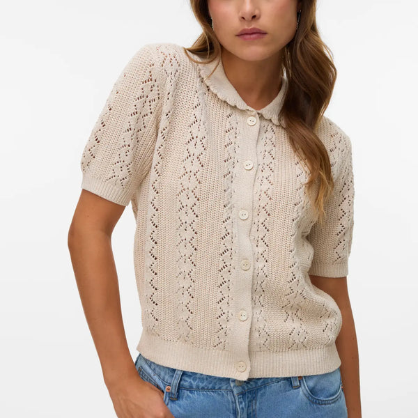 Soft neutral pointelle knit sweater cardigan with short sleeves, button-front closure and vintage-inspired silhouette for spring and summer layering.