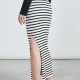 Contemporary women’s striped skirt with side slit and trendy minimalist street-style aesthetic.