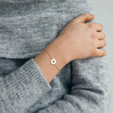 Minimalist compass jewelry bracelet in gold perfect for stacking and daily wear.