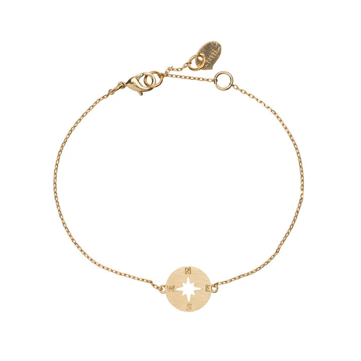 Women’s delicate gold compass rose bracelet with minimalist chain and travel-inspired charm.