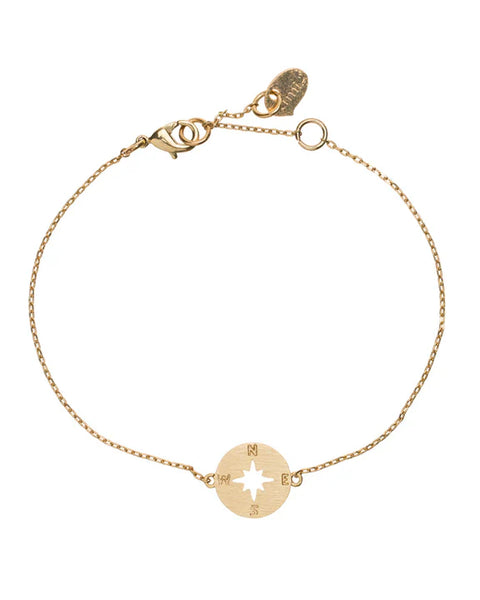 Women’s delicate gold compass rose bracelet with minimalist chain and travel-inspired charm.