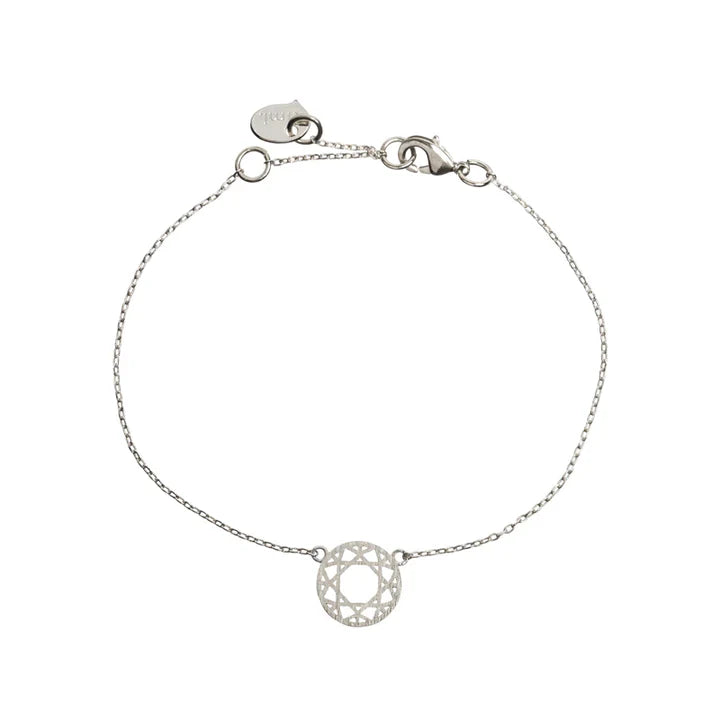 Lightweight silver bracelet with intricate mandala-inspired charm and modern jewelry styling.