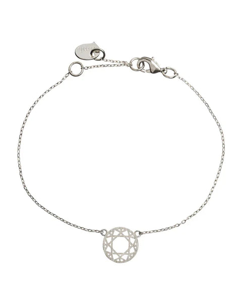 Lightweight silver bracelet with intricate mandala-inspired charm and modern jewelry styling.