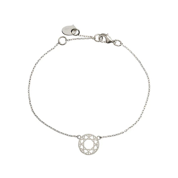 Lightweight silver bracelet with intricate mandala-inspired charm and modern jewelry styling.