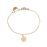 Women’s delicate gold monstera leaf bracelet with minimalist chain and tropical-inspired design.