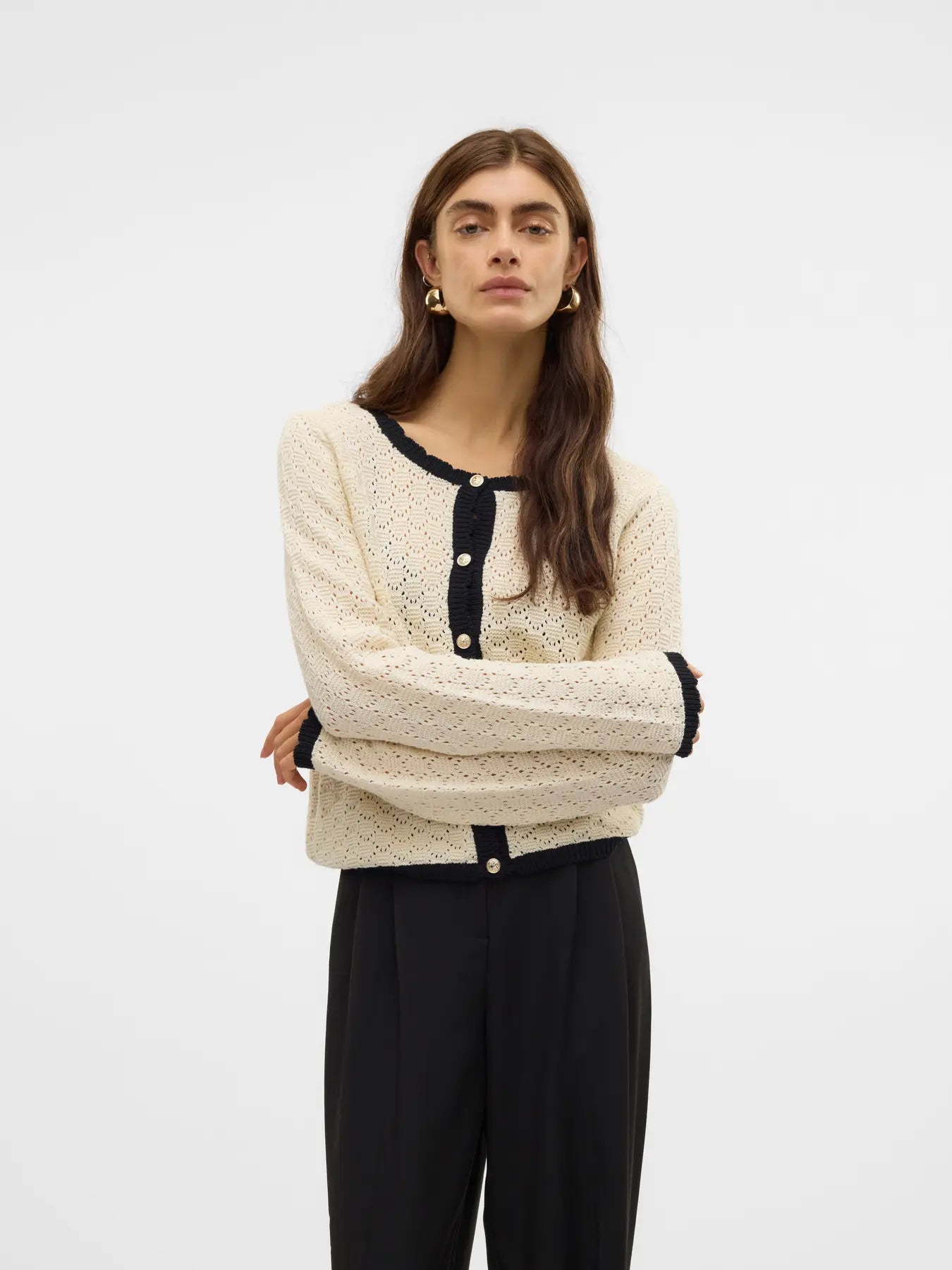 Women's ivory pointelle knit cardigan with black contrast trim, pearl-effect buttons and cropped silhouette for elegant everyday and office style.