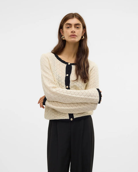Women's ivory pointelle knit cardigan with black contrast trim, pearl-effect buttons and cropped silhouette for elegant everyday and office style.
